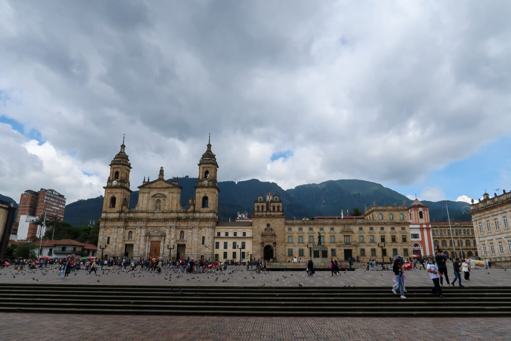People roaming around Plaza de Bolivar on a cloudy day