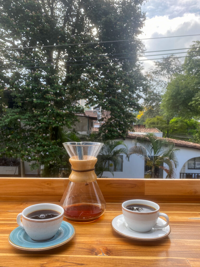 Two cups of coffee on a wooden table. Drinking Colombian coffee is one of the things to do in Bogota.