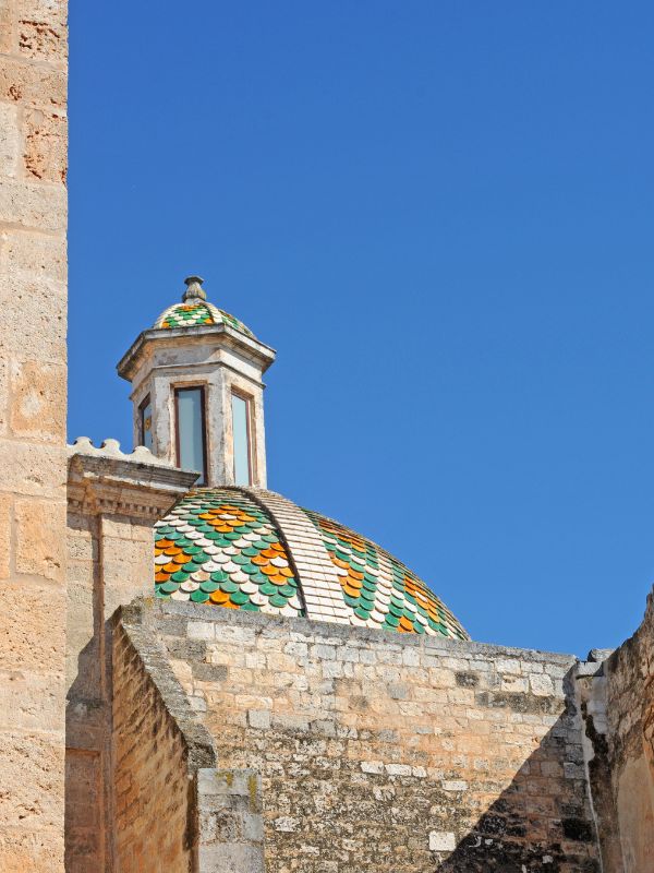Colorful tiled dome of the Ostuni Cathedral under the blue sky
