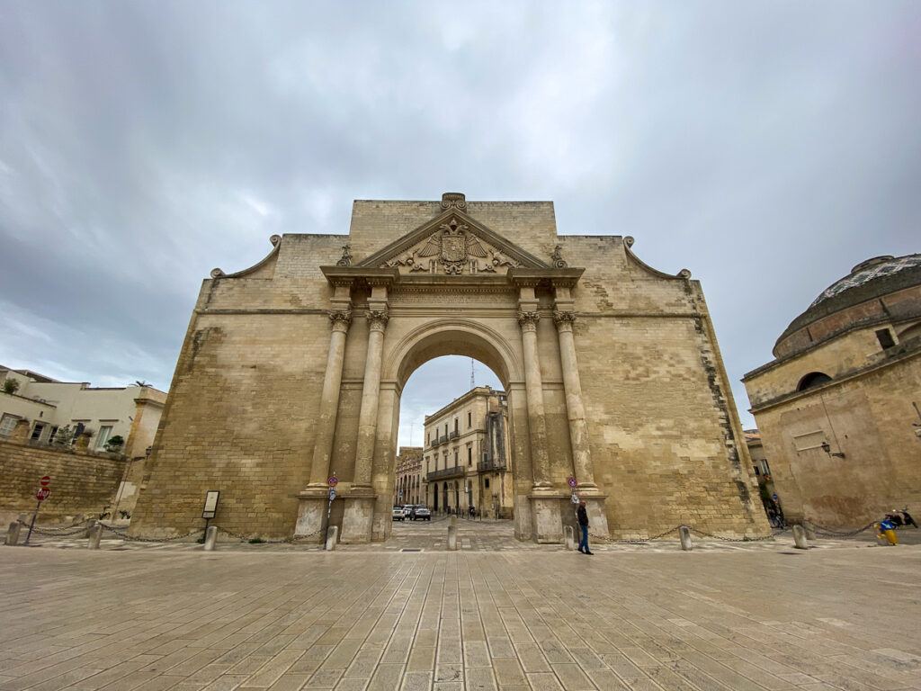 Porta Napoli under the gloomy sky. This guide to Lecce, Italy recommends passing through the three city gates of Lecce.
