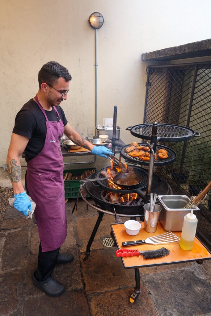 Chef cooking in the open-kitchen space at Prudencia