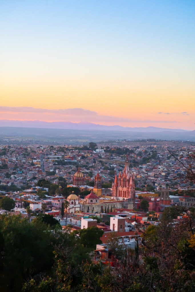 View of the city of San Miguel de Allende from the Mirador viewpoint at sunset. Witnessing this beautiful landscape from the Mirador is one of the best things to do in San Miguel de Allende.
