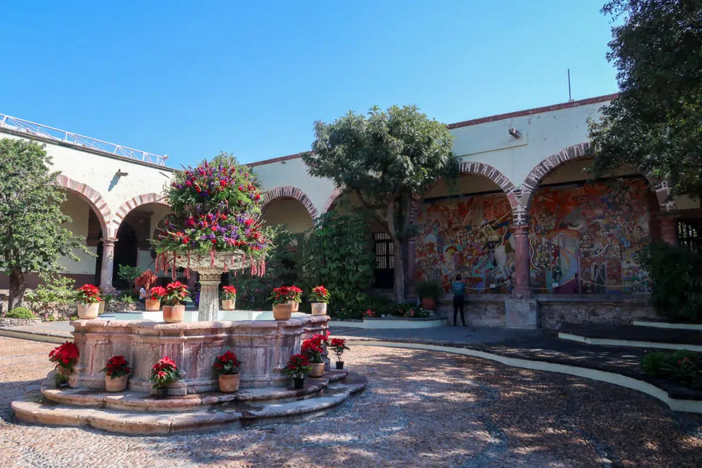 Flower-decorated fountain in the central courtyard of Instituto Allende. Visiting this art school is one of the best things to do in San Miguel de Allende.