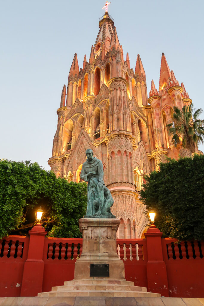 Statue of Fray Juan de San Miguel in front of the Parroquia de San Miguel Arcángel. Visiting this church is one of the magical things to do in San Miguel de Allende, Mexico.