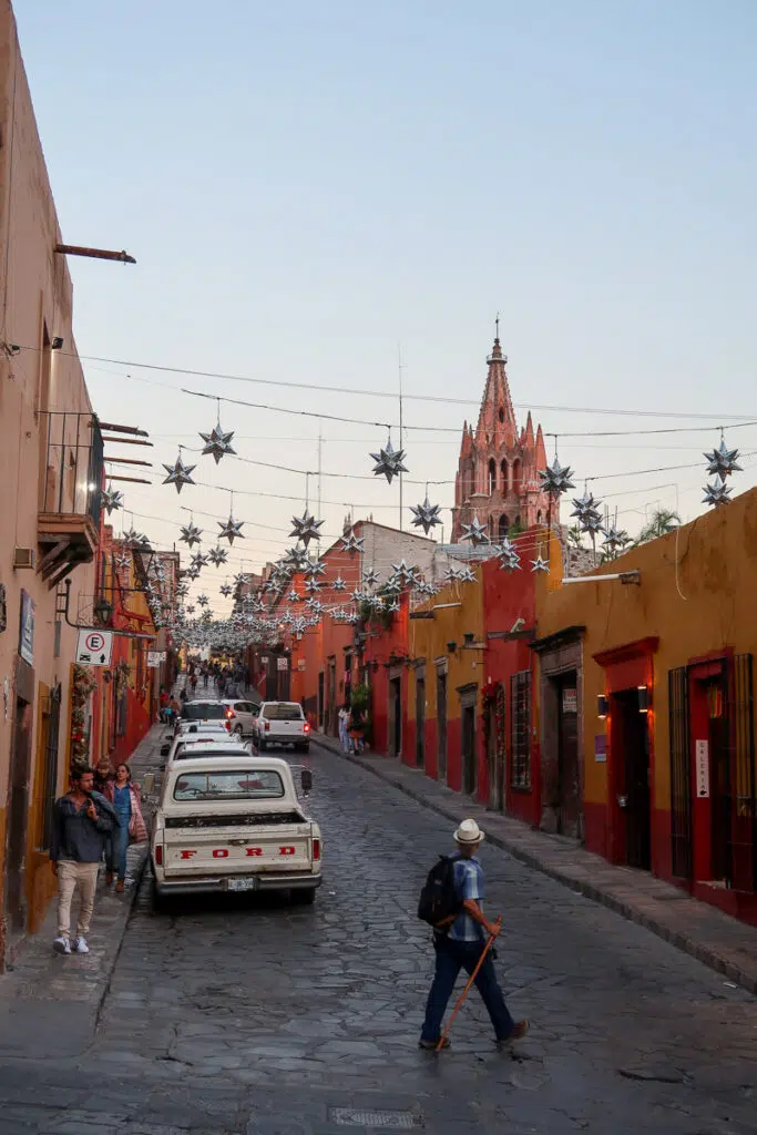 People walking along the cobblestone street of San Miguel de Allende