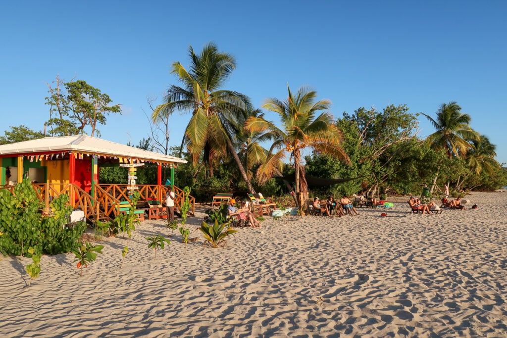 People hanging out at. a beach bar on the sand on the island of Providence, Colombia