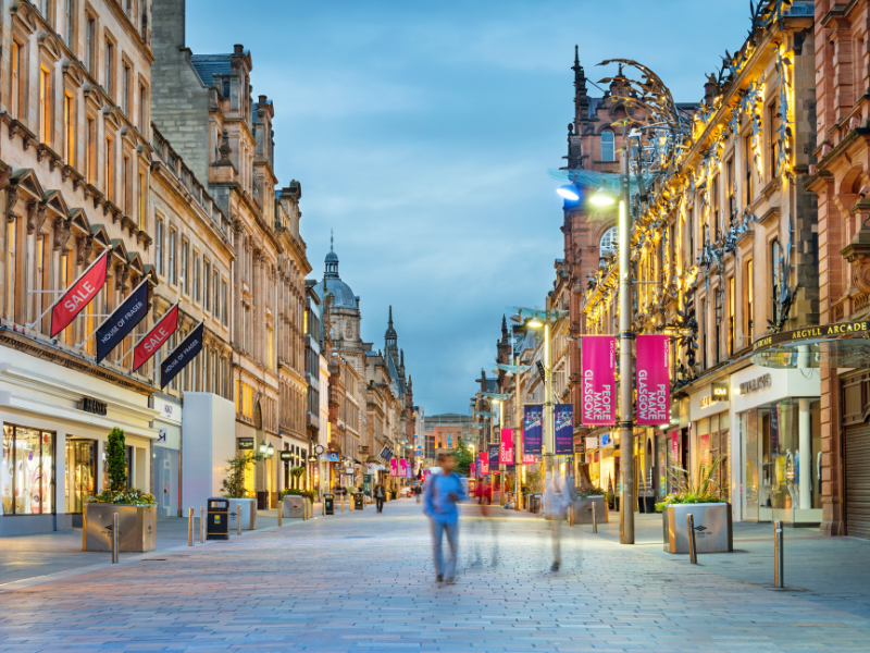 A busy shopping street in Glasgow. In Edinburgh vs. Glasgow, the shopping is better in Glasgow.