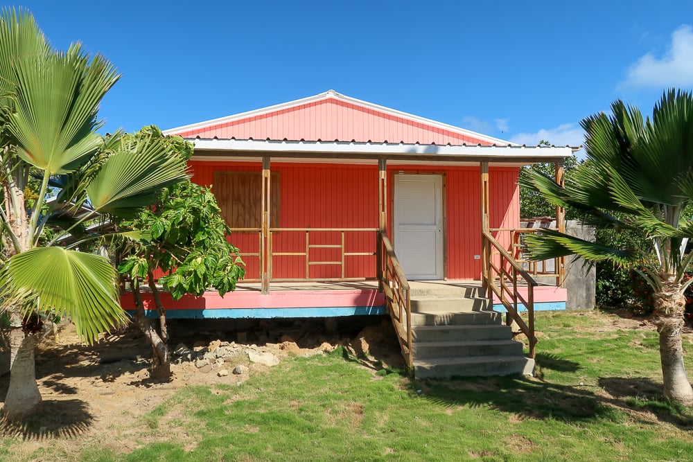 Pink house in Providencia surrounded by trees