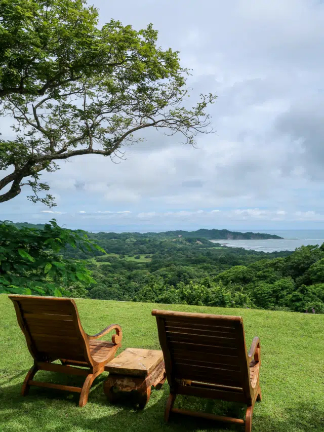 Wooden lounge chairs with a wide view of the beauty of Nosara