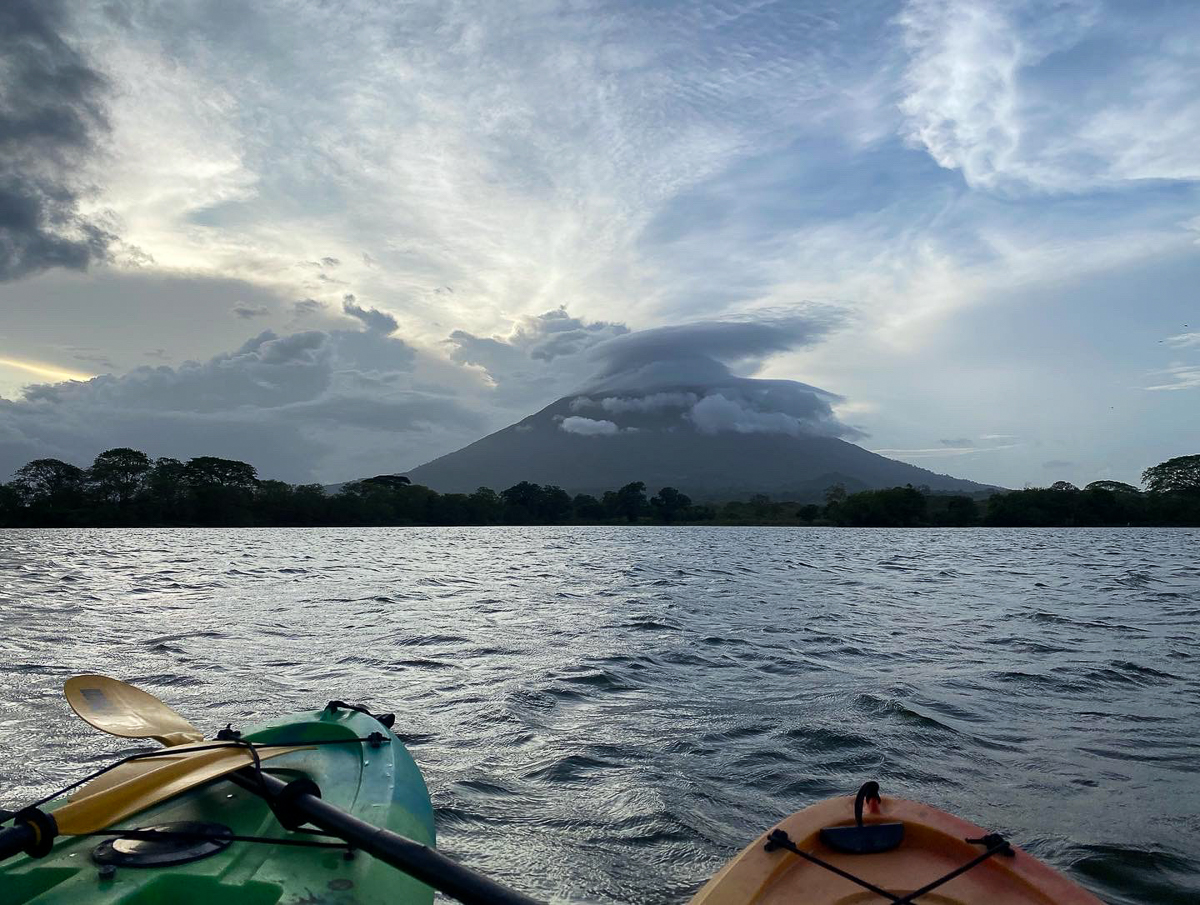 Two kayaks on a lake at sunset. Kayaking on Lake Nicaragua is one of the best things to do in Ometepe.
