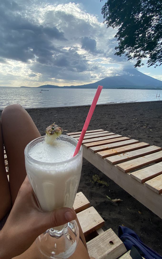 Enjoying a cold drink on the beach with a view of one of the two volcanoes in Isla de Ometepe