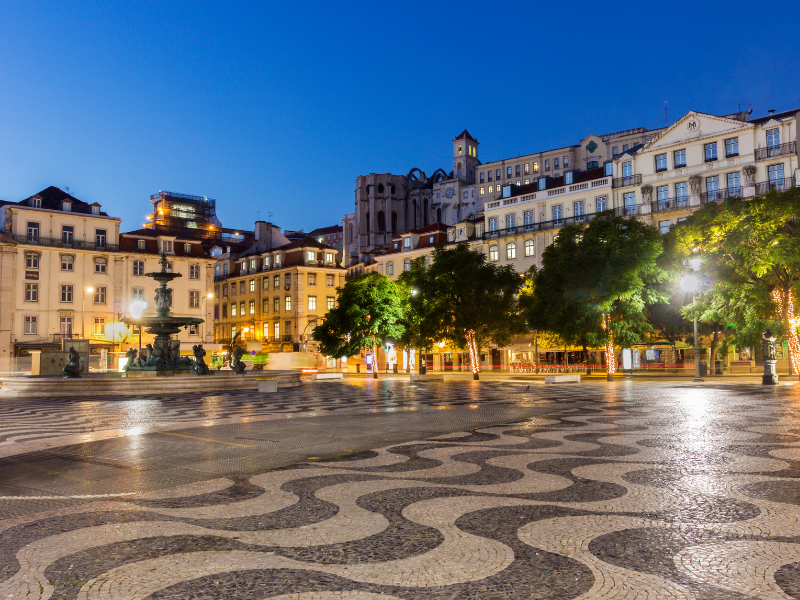 Rossio Square lit up at night in Lisbon