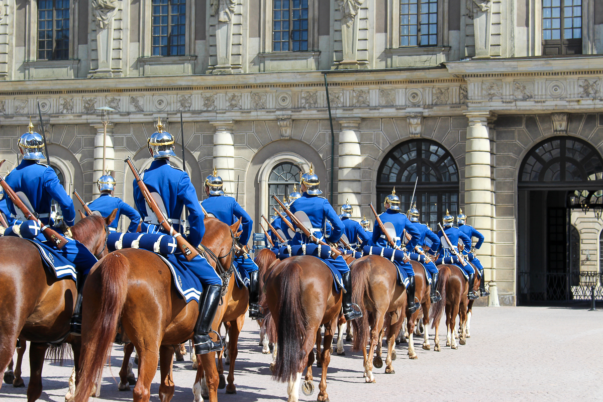 Changing of the guard ceremony at the Royal Palace in Stockholm with lots of men in uniform on horses