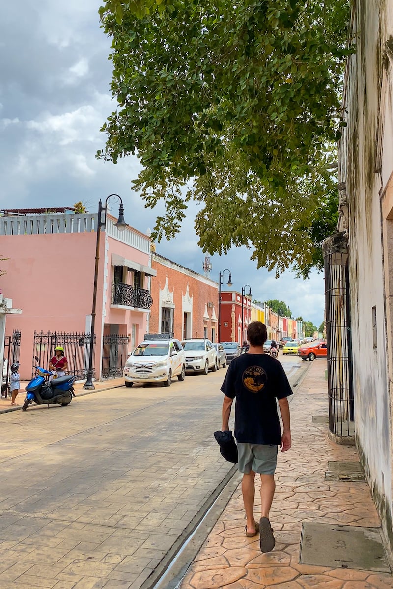 Cacey walking down a street in Valladolid, Yucatan. Roaming the colorful El Centro neighborhood is one of the best things to do in Valladolid!