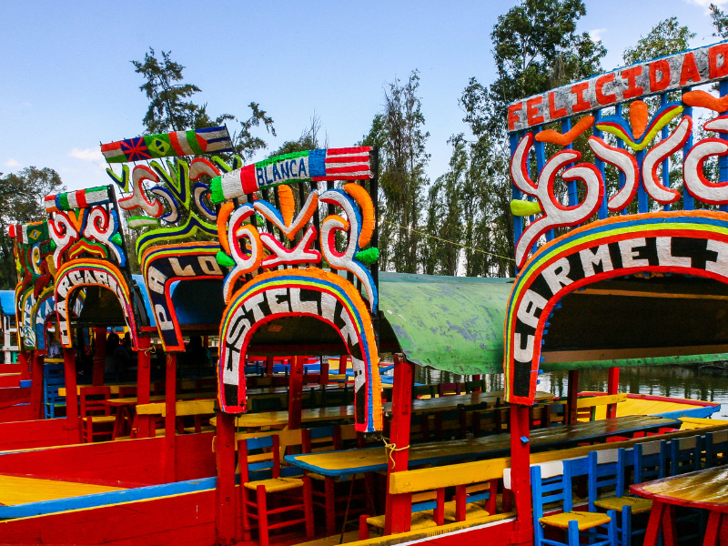 Dozens of colorful floating boats on the canals in Xochimilco. This is a must-do in Mexico City.