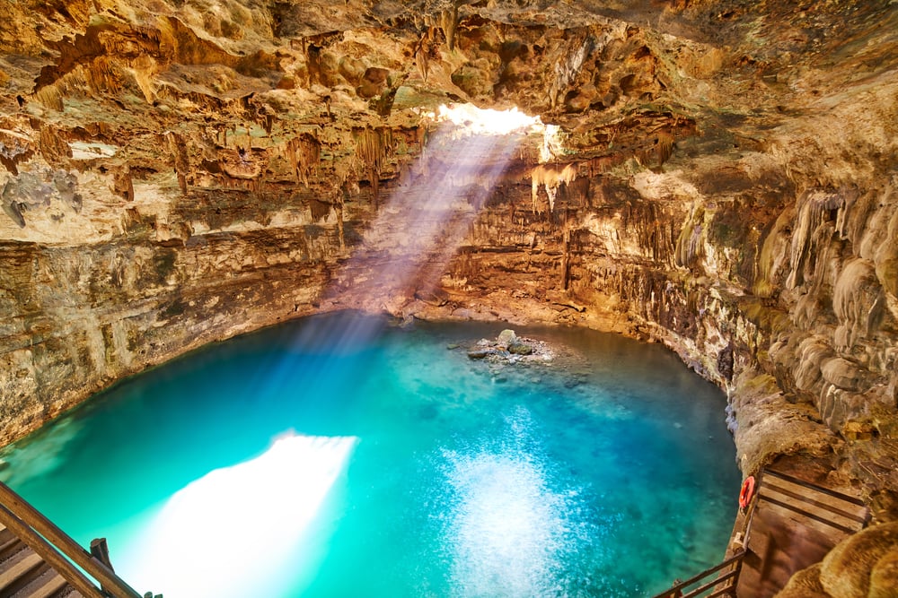 Sunlight passing through the roof of Cenote Samula. Exploring more cenotes is one of the best things to do in Valladolid, Mexico.