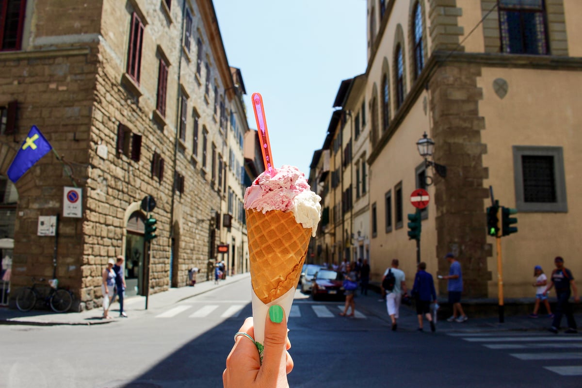 Holding up a cone of gelato in the streets of Florence. During your 3 days in Florence, don't miss out on a gelato break.