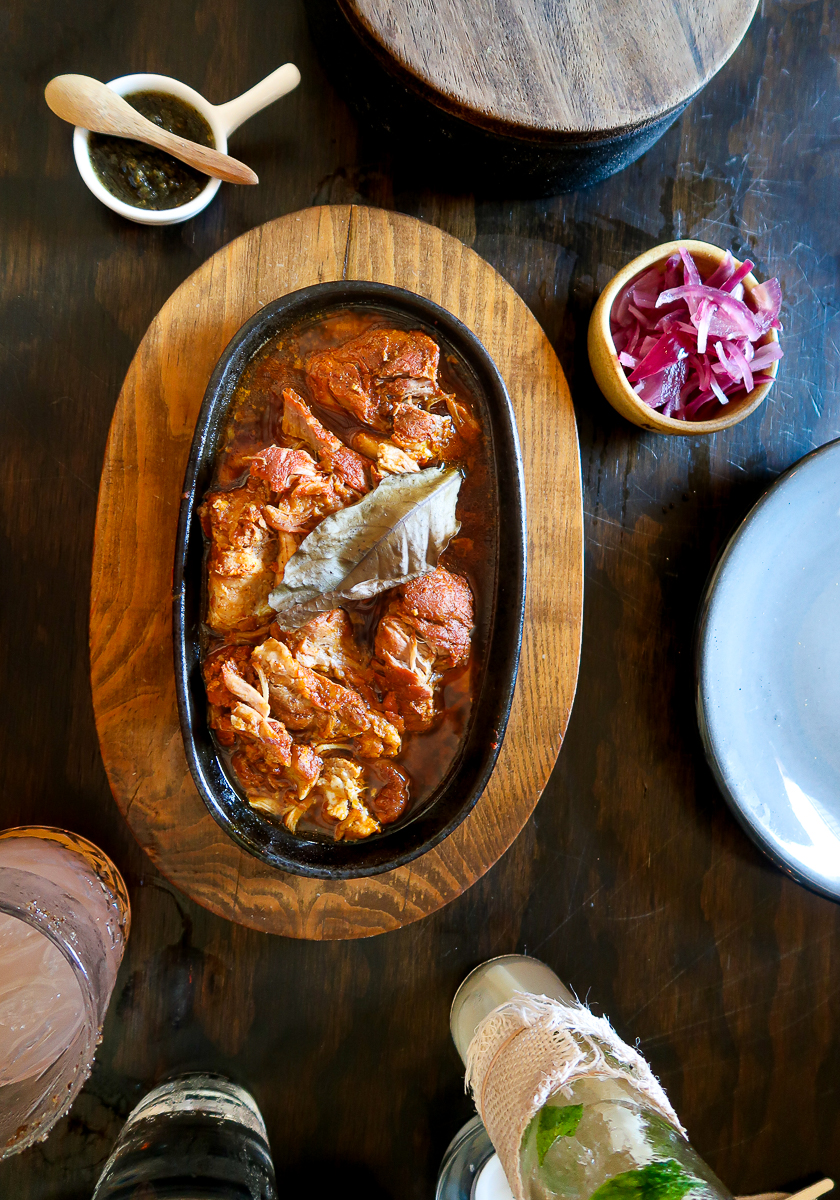 Delicious plate of cochinita pibil at a Yucatecan restaurant. Wondering what to eat in Izamal? Try some traditional Yucatecan food like the cochinita pibil.