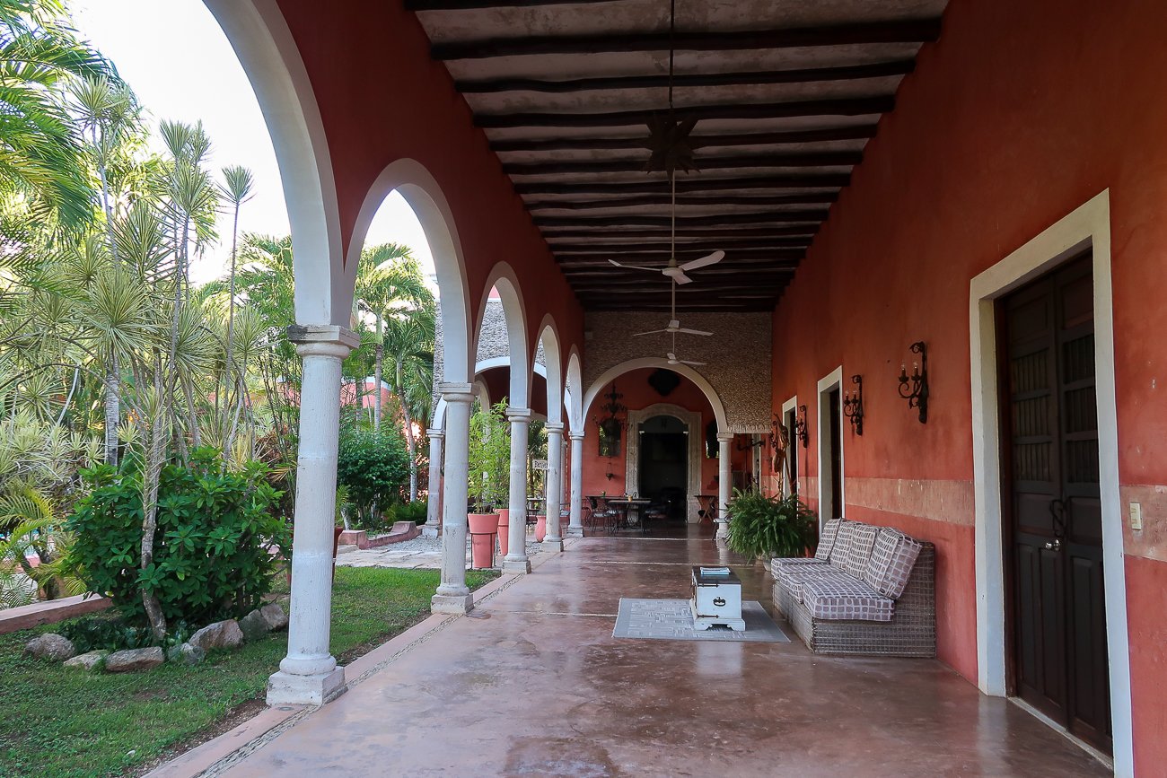 Quiet hallway at Hacienda Sacnicte lined with archways