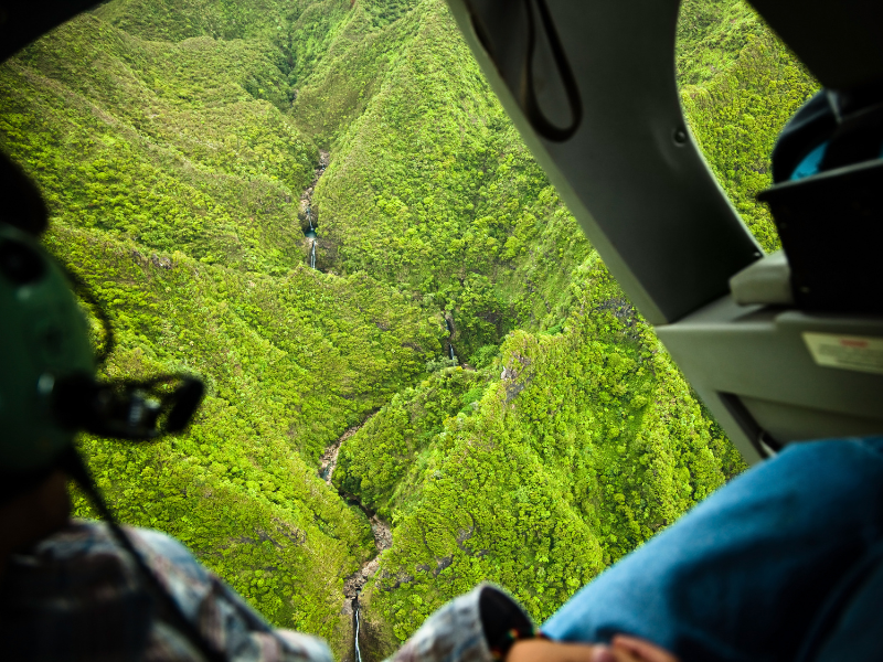Breathtaking view of Sacred Falls from a helicopter. This guide to Oahu includes booking helicopter tours to enjoy the beautiful sceneries of Hawaii.