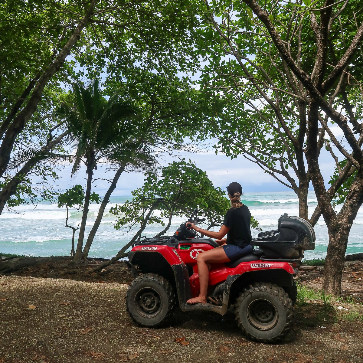 Maddy riding an ATV while admiring the beautiful ocean views of Costa Rica