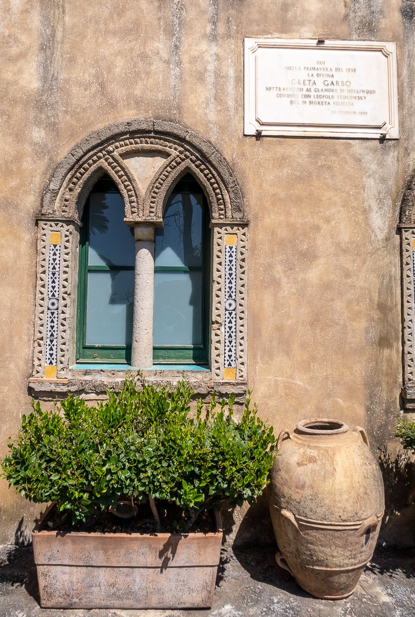 Quaint window and a stone plaque of Greta Garbo, a movie actress who stayed here in the early 1900s