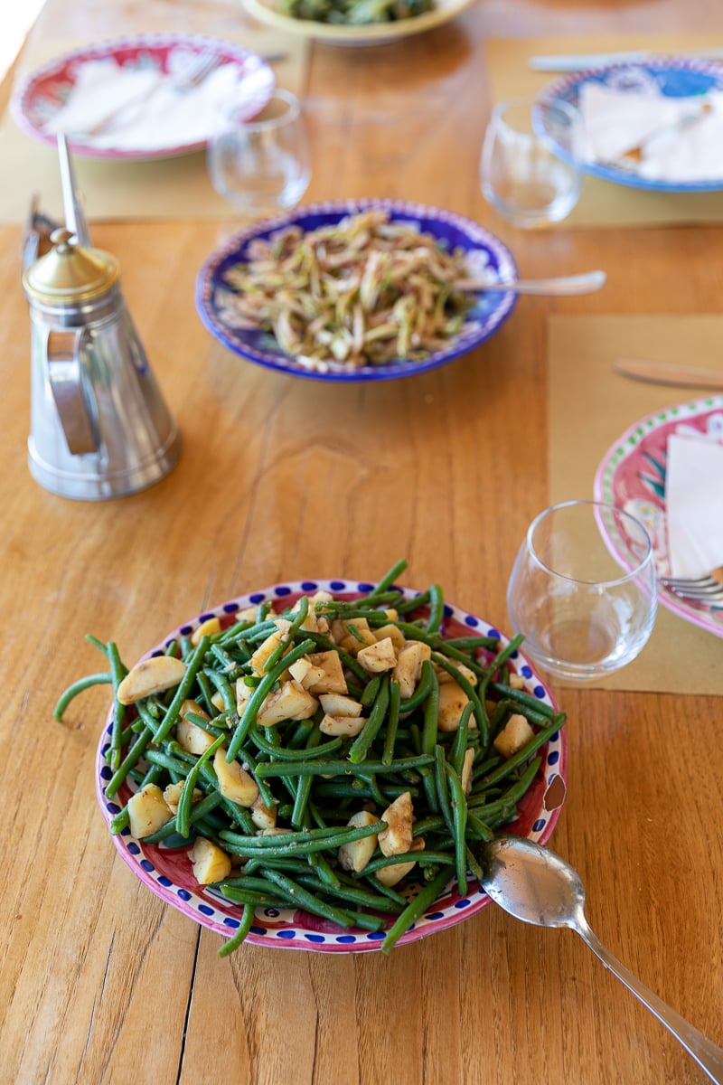 Two salads in colorful dishes on a wooden table