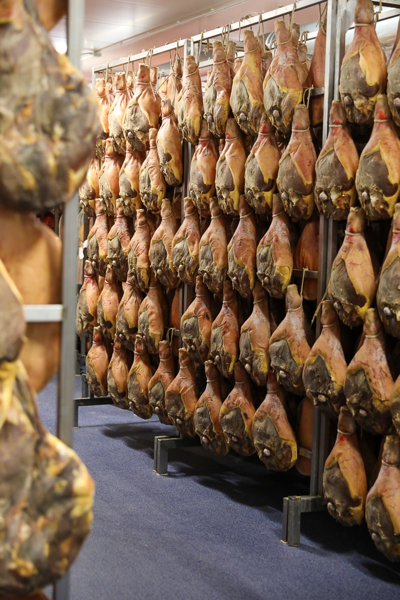 Legs of ham strung up and aging in a ham factory