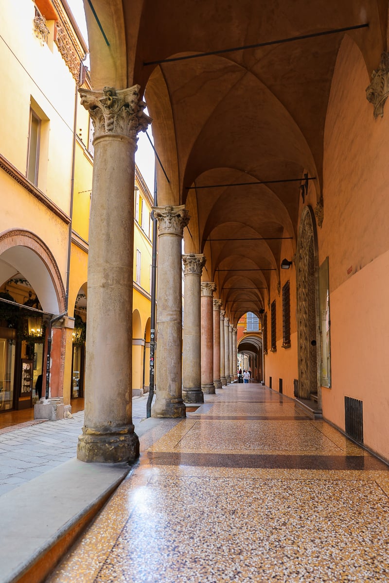 A portico walkway with vaulted arch ceilings and tile floors