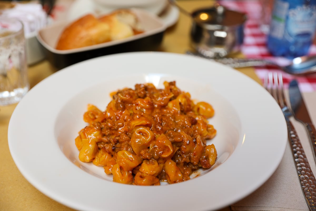 A plate of tortellini with ragu alla bolognese