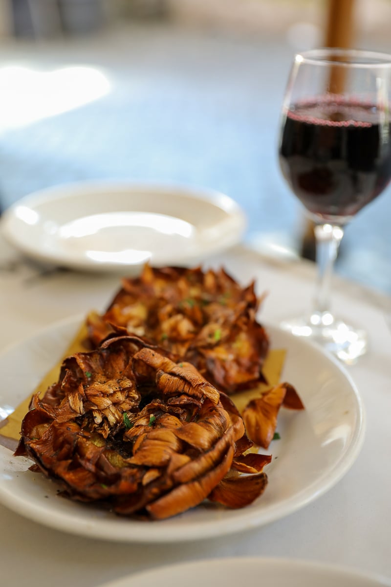 Fried artichokes and a glass of red wine in Rome