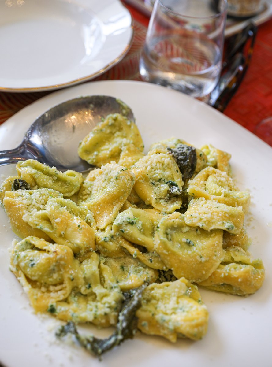 A plate of ricotta tortelloni with sage leaves