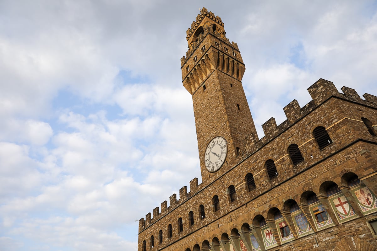Partial view of the facade of the Palazzo Vecchio and its bell tower on a cloudy day in Florence