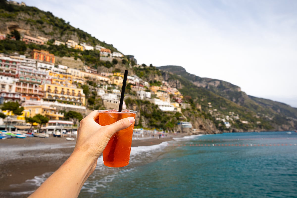 Holding up a cup of Aperol Spritz from L'Alternativa Bar - one of the best bars in Positano