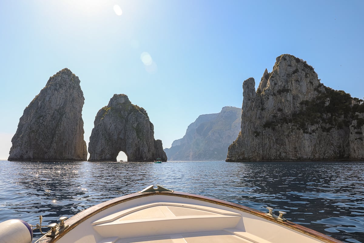 Tall rock formations in the middle of the sea during a boat tour
