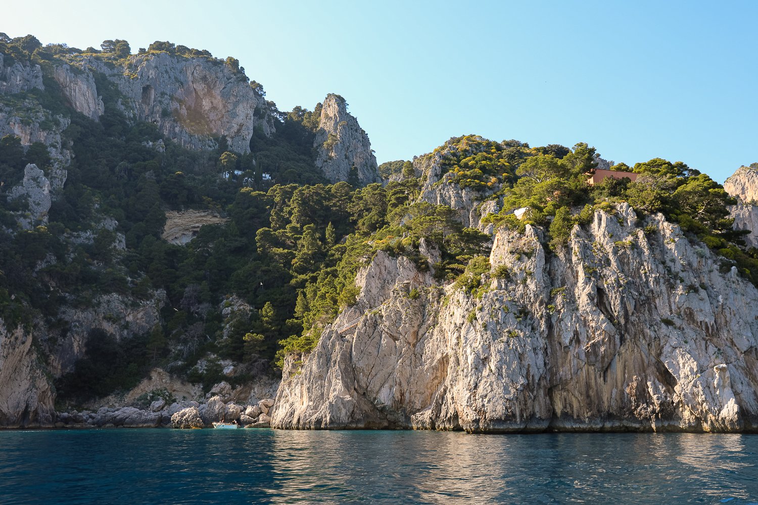 View of the island's rocky cliffside as seen from a boat