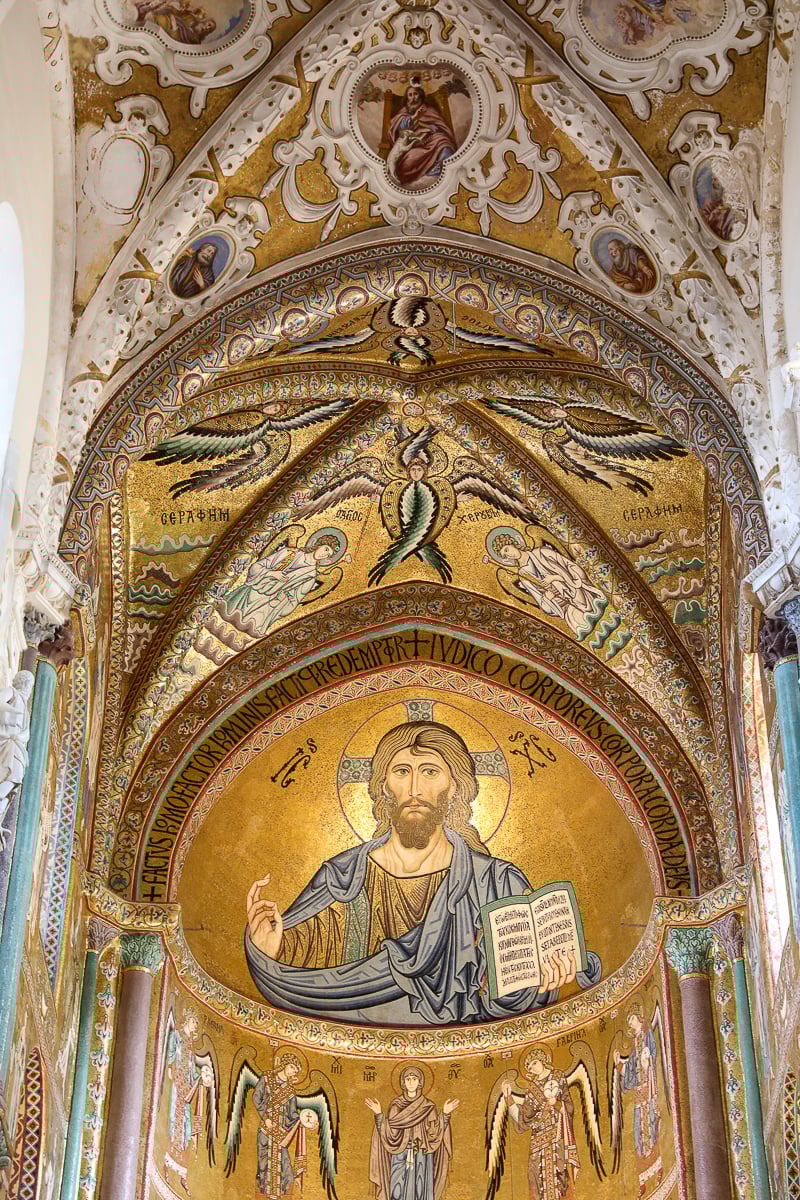 Intricate interior of Cefalù cathedral with an image of Christ Pantokrator on its ceilings