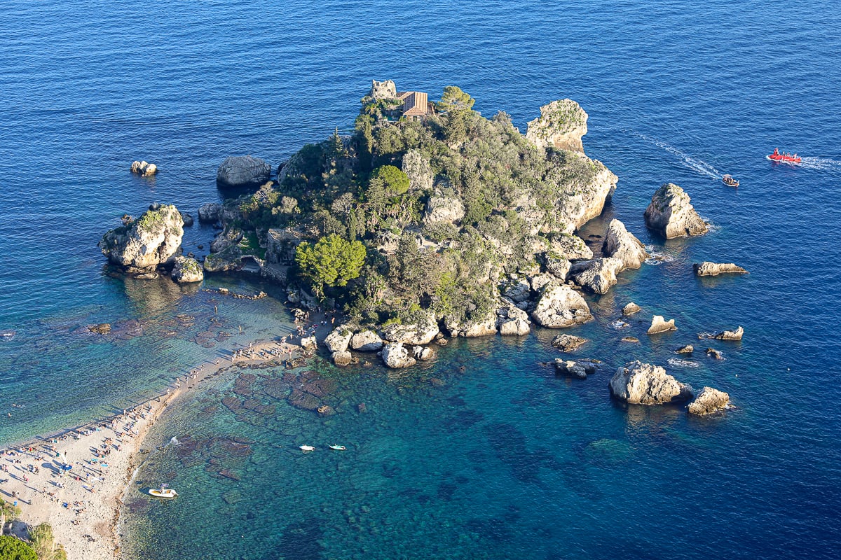 A small island with lots of rocks near a shoreline