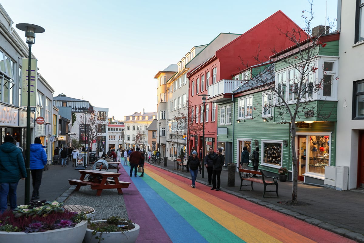 People strolling along the Rainbow Street surrounded with colorful shops and cafés