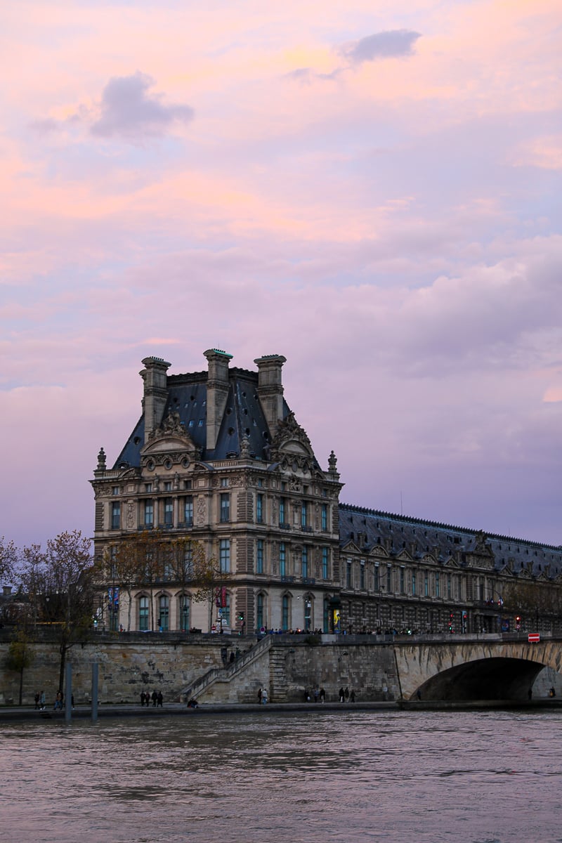 Louvre Museum along the Seine River at sunset during a Paris river cruise