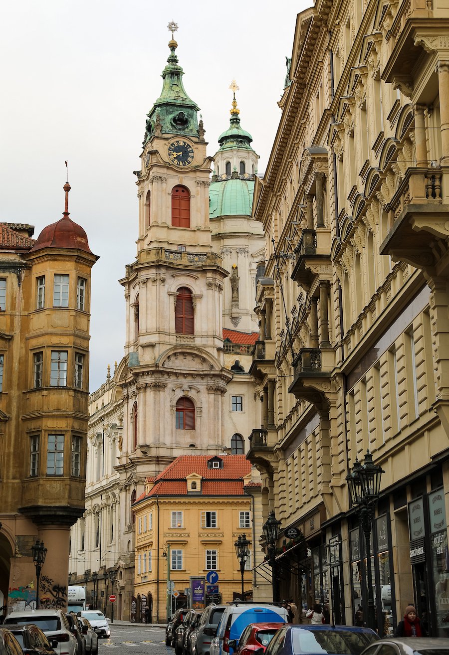 A street in Mala Strana with St Nicholas Church's dome looming over the scene