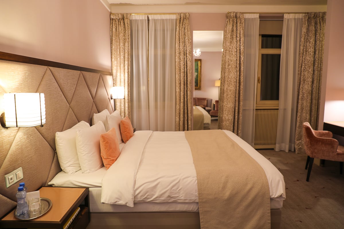 Elegant hotel room at Aria Hotel Prague with plush bedding, neutral tones, and soft lighting, an example of stylish accommodations when deciding where to stay in Prague.