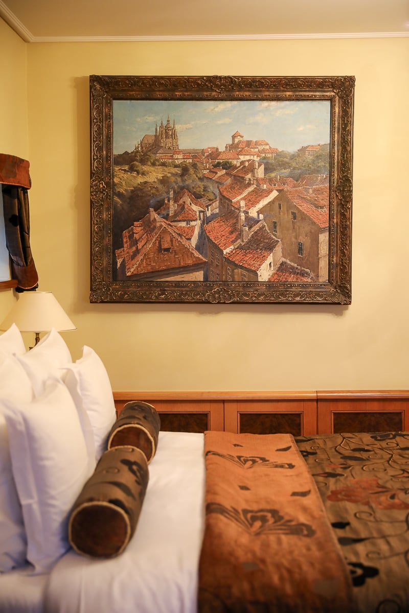 Luxury room at the Golden Well Hotel Prague with refined furnishings and traditional artwork, highlighting upscale options for where to stay in Prague.