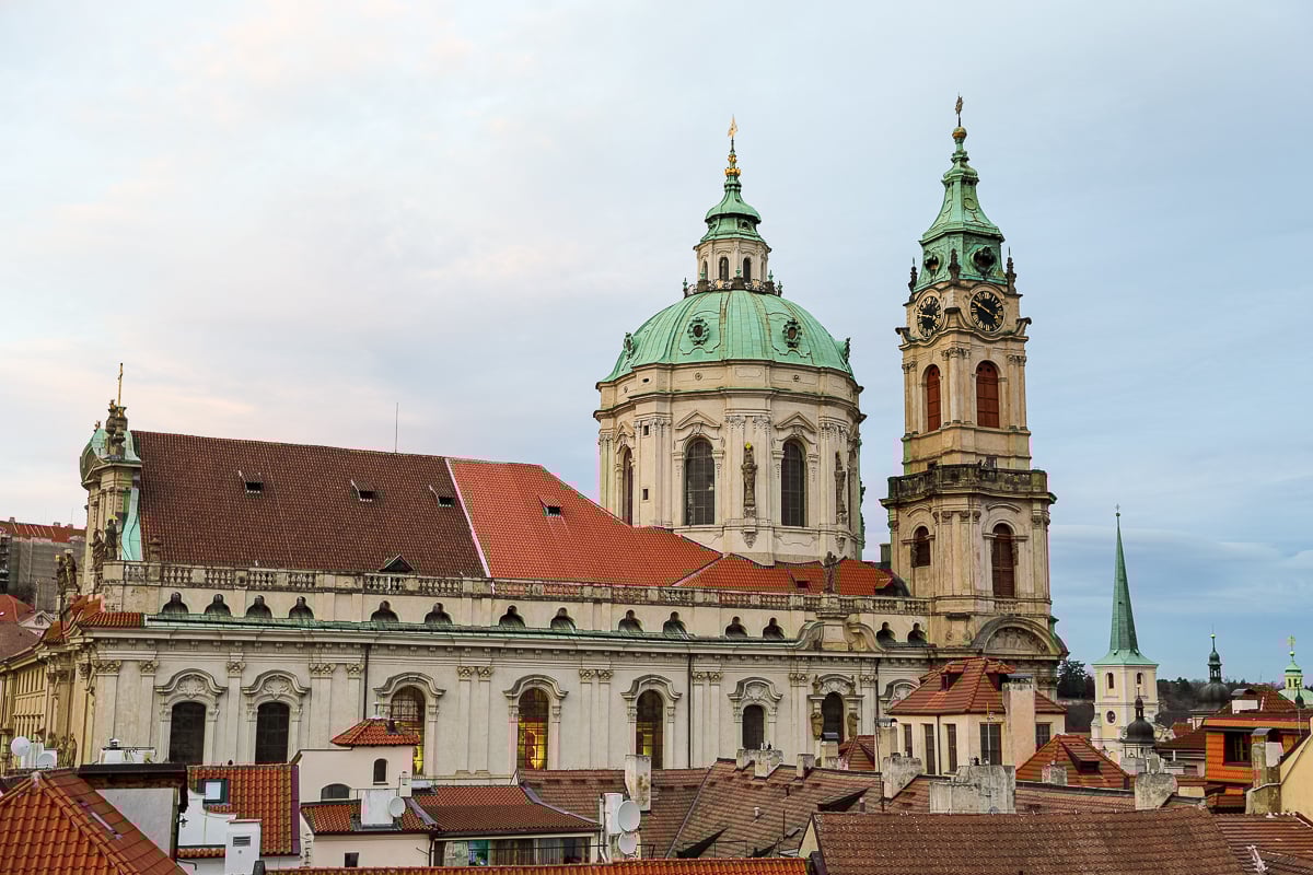 View of the towers and dome of the Church of St Nicholas from a rooftop in Malá Strana, Prague