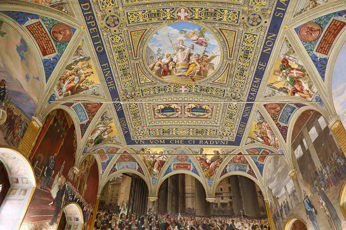 Ornate frescoed ceiling inside the Palazzo Pubblico in Siena