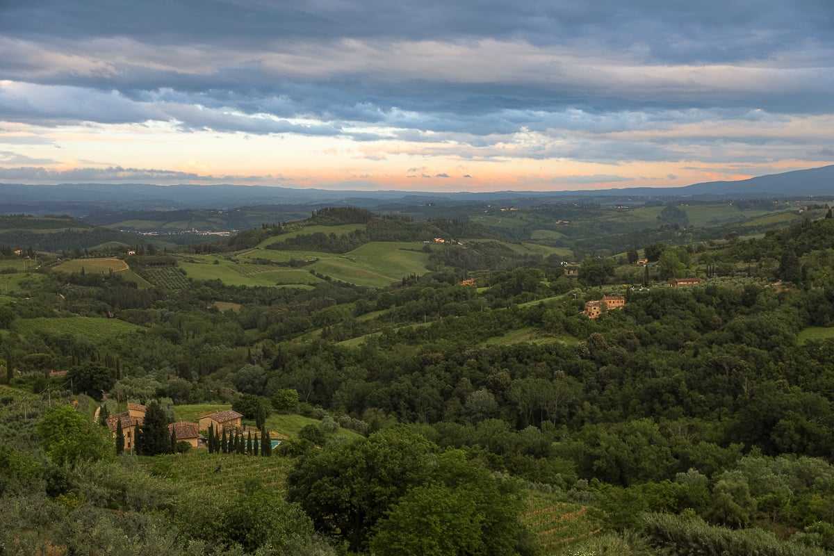 Rolling green hills and vineyards in the Tuscan countryside near Siena