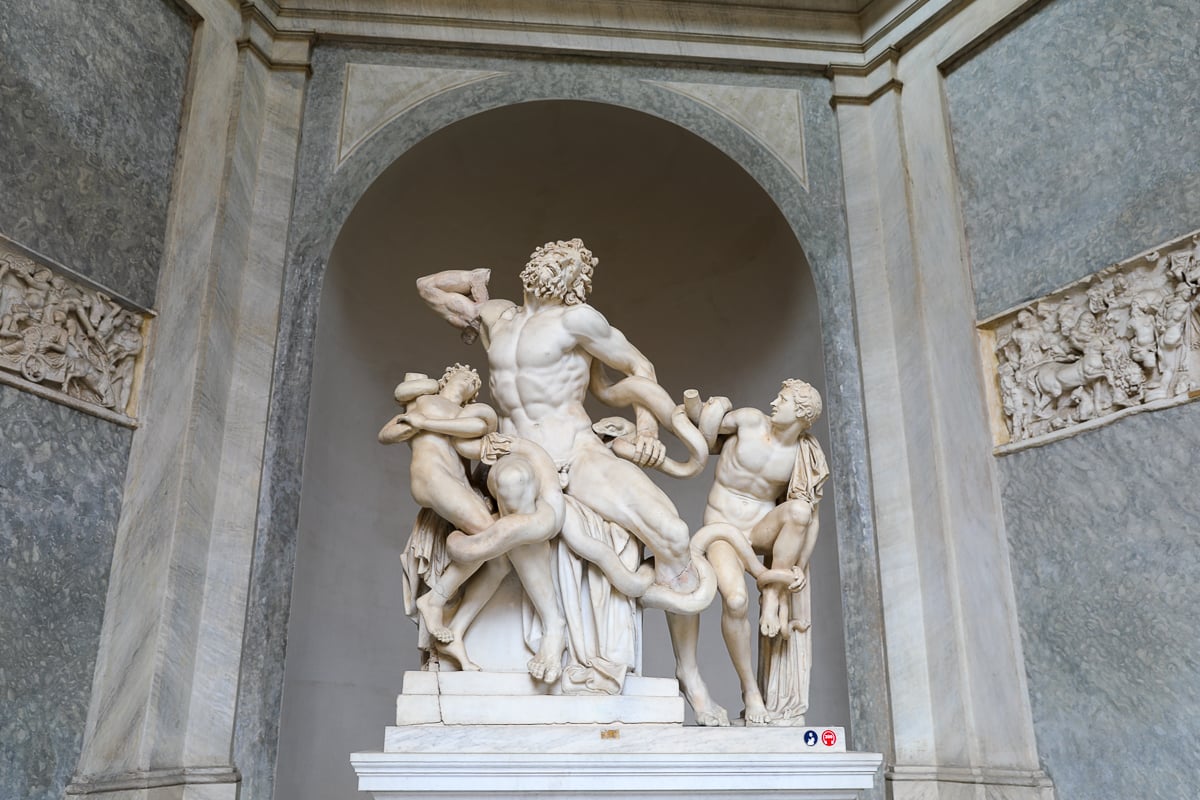Laocoön and His Sons statue in the Vatican Museums depicting the dramatic struggle with serpents carved in white marble