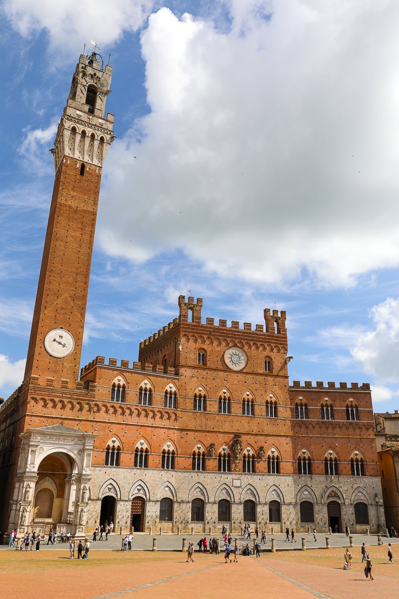 Palazzo Pubblico and Torre del Mangia dominating Piazza del Campo in Siena on a sunny day