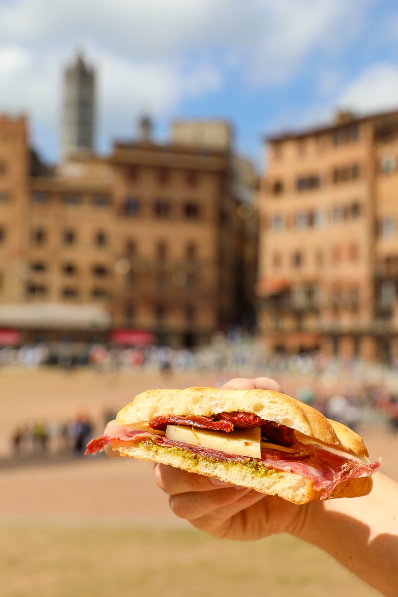 Classic Italian panino with salami, cheese, and sun-dried tomatoes in Siena