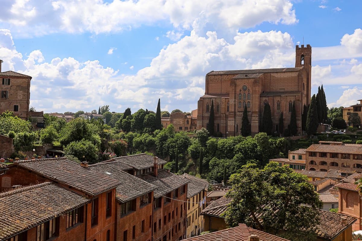 View across Siena toward the Basilica of San Domenico surrounded by cypress trees